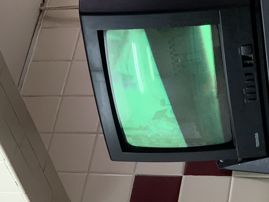 An old Toshiba CRT television glowing green